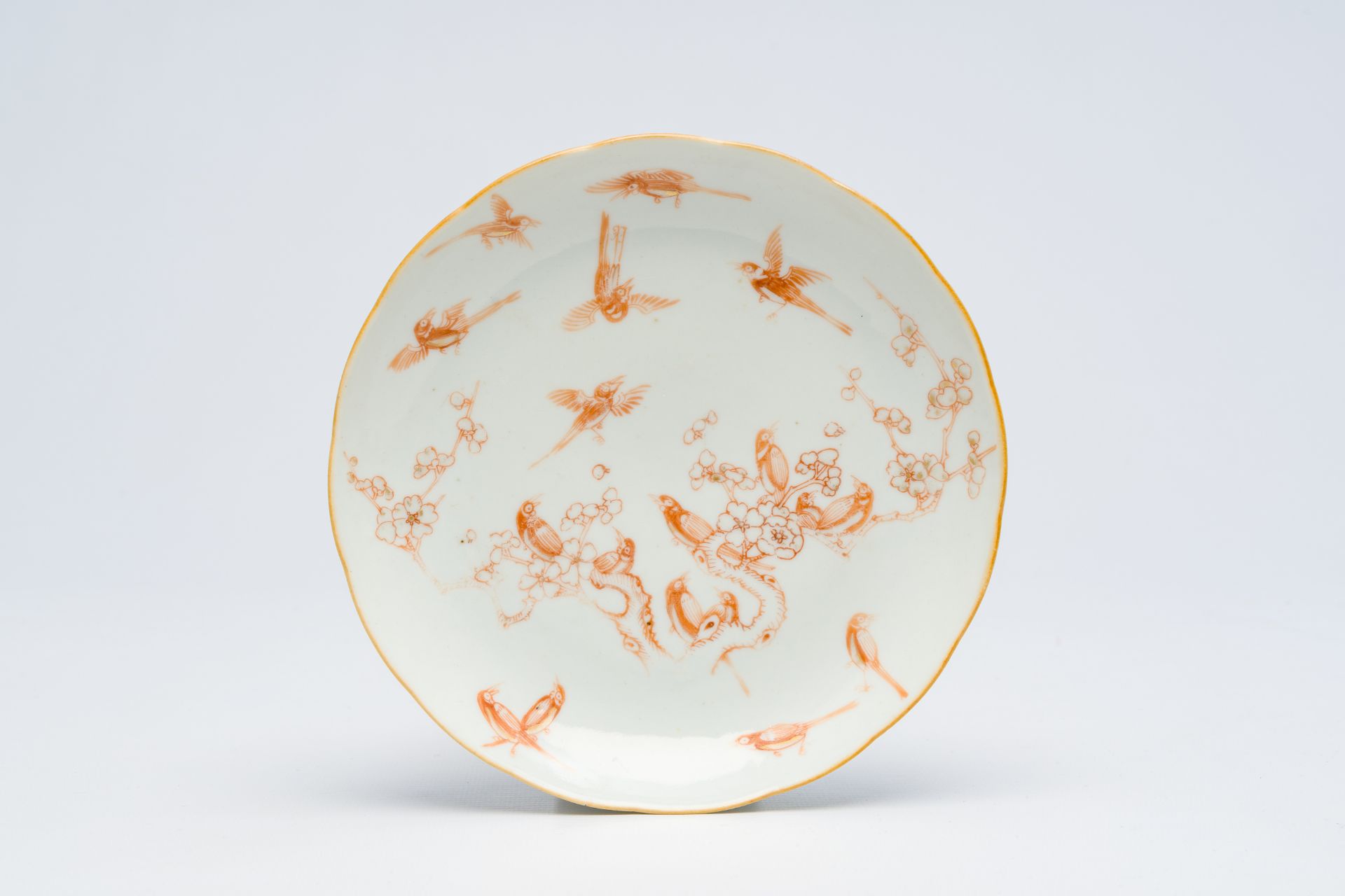 A Chinese iron-red plate with birds among blossoming branches, Daoguang mark, 19th C.