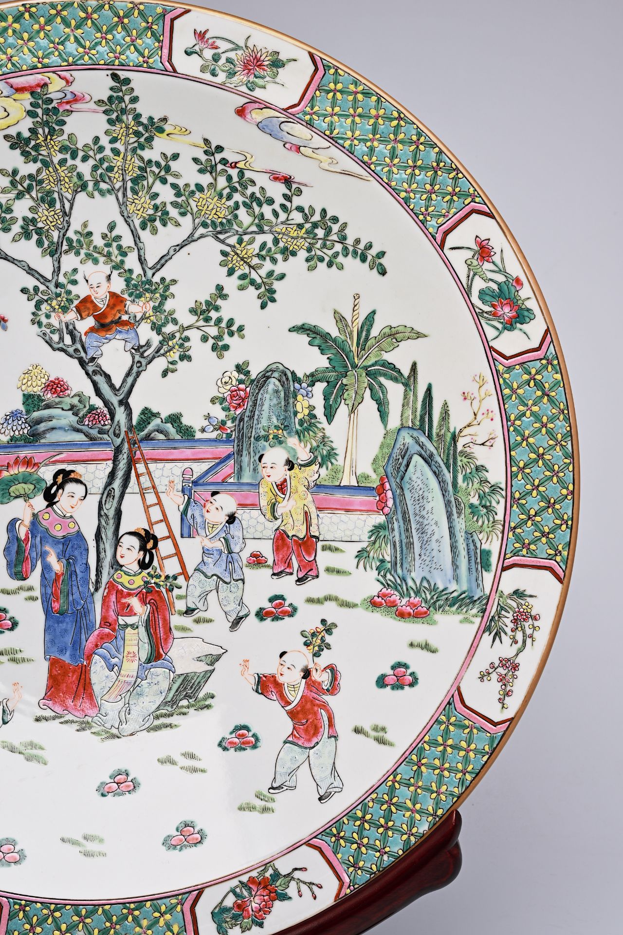 A large Chinese famille rose dish with ladies and children in a landscape, Qianlong mark, 20th C. - Image 11 of 16