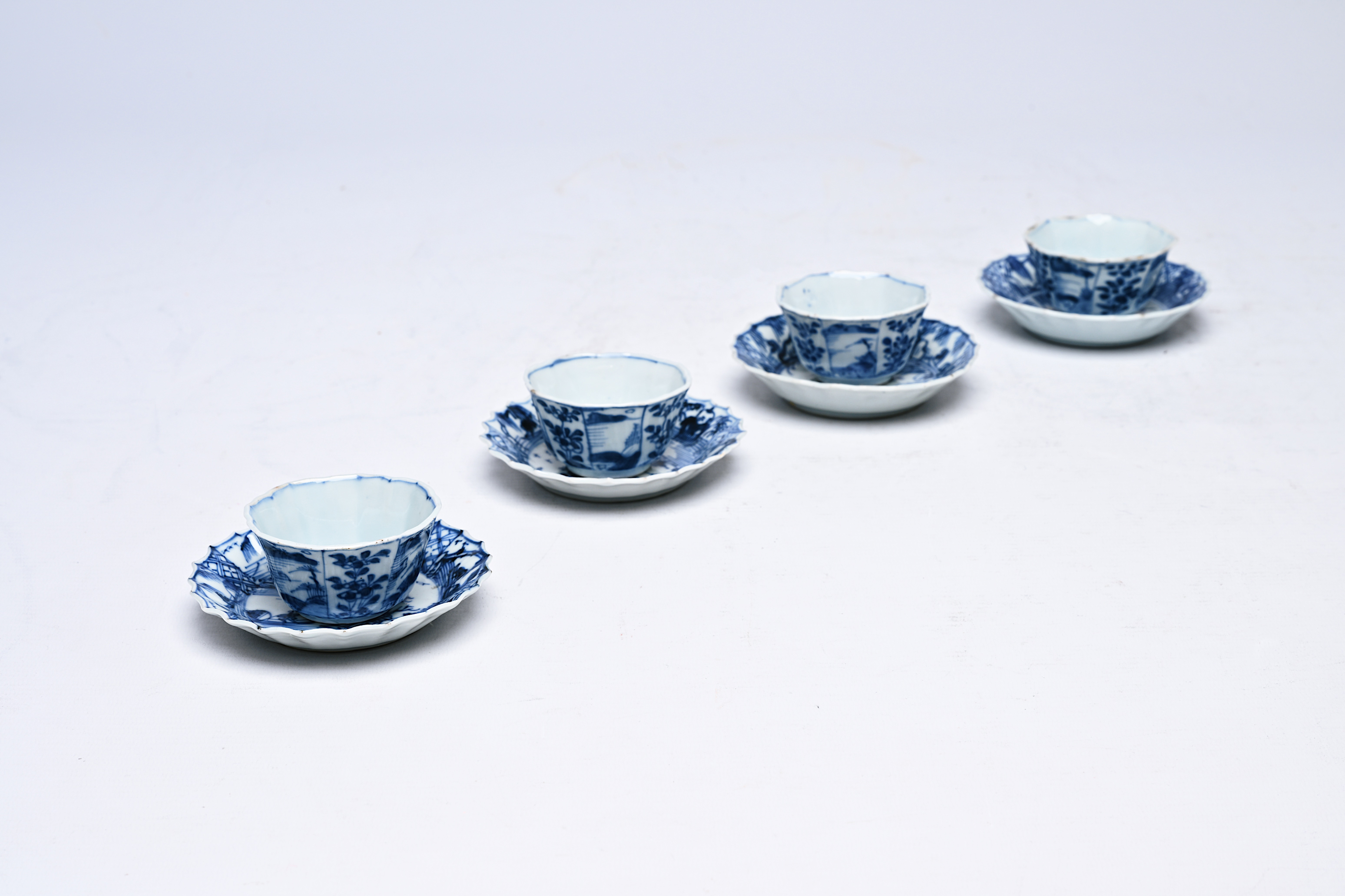 Four Chinese blue and white cups and saucers with floral design and landscapes, Kangxi - Image 8 of 12