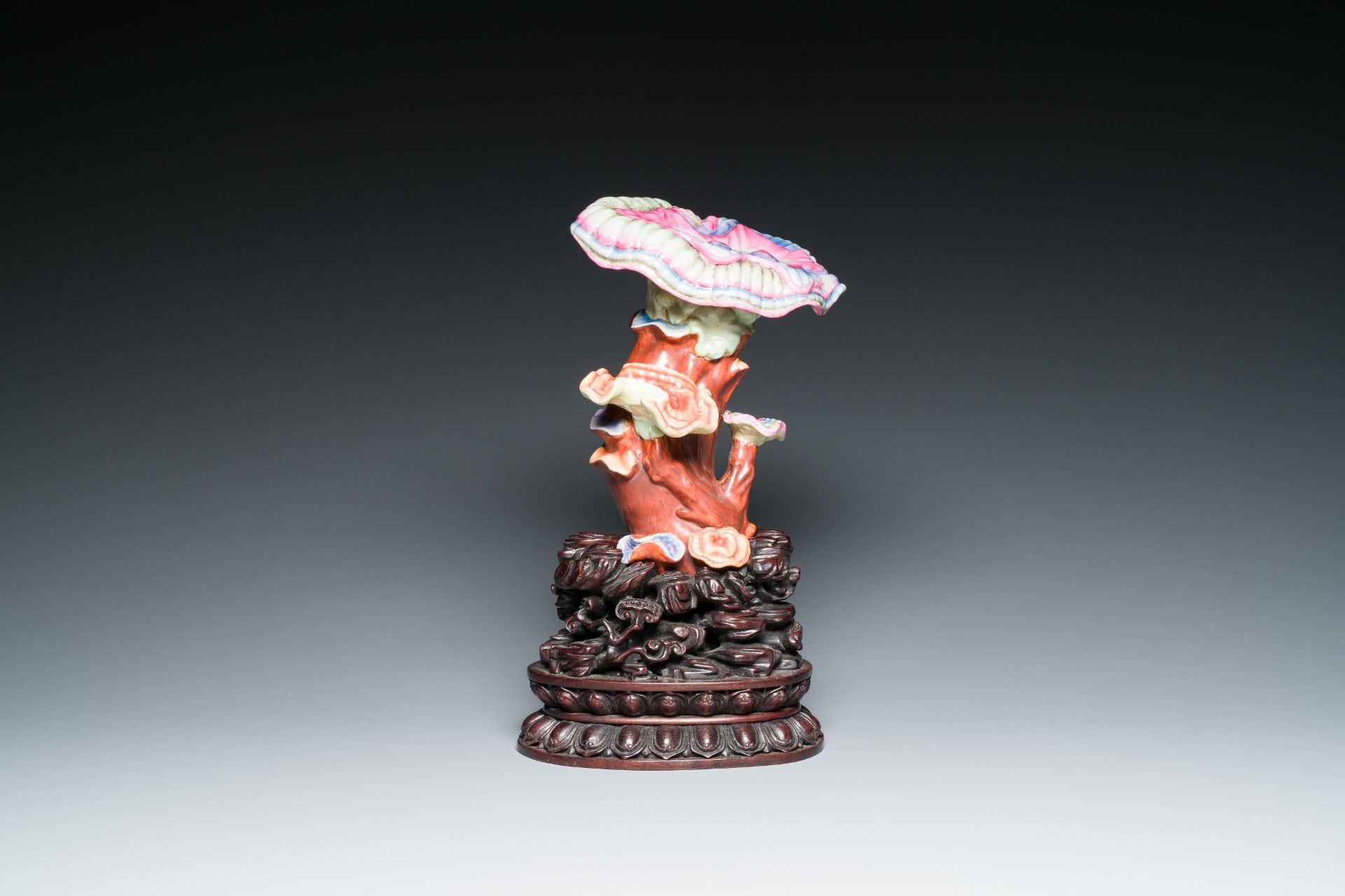 A Chinese famille rose 'lingzhi' sculpture on a carved wood stand, Qianlong mark, probably Republic