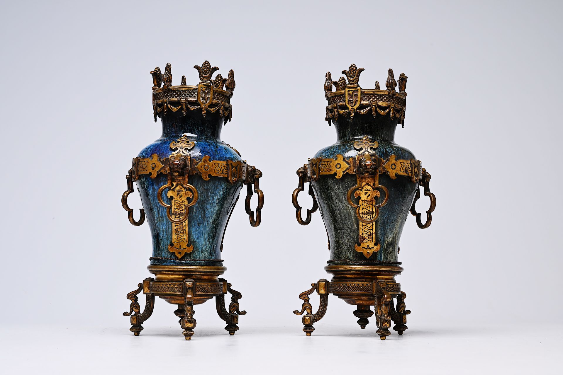 A pair of Chinese flambe glazed vases with gilt bronze mounts, 19th C.
