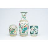 A Chinese famille rose vase and two ginger jars with birds among blossoming branches, 19th C.