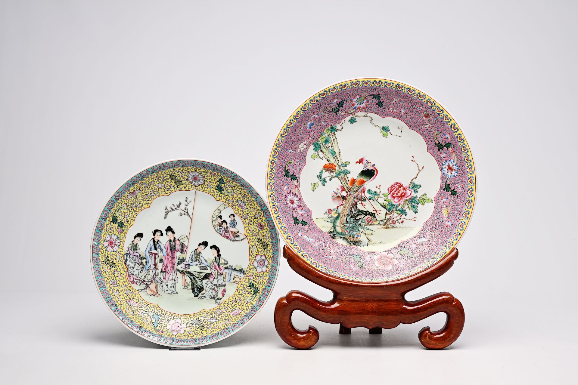 Two Chinese famille rose dishes with phoenixes among blossoming branches and ladies on a terrace, Qi