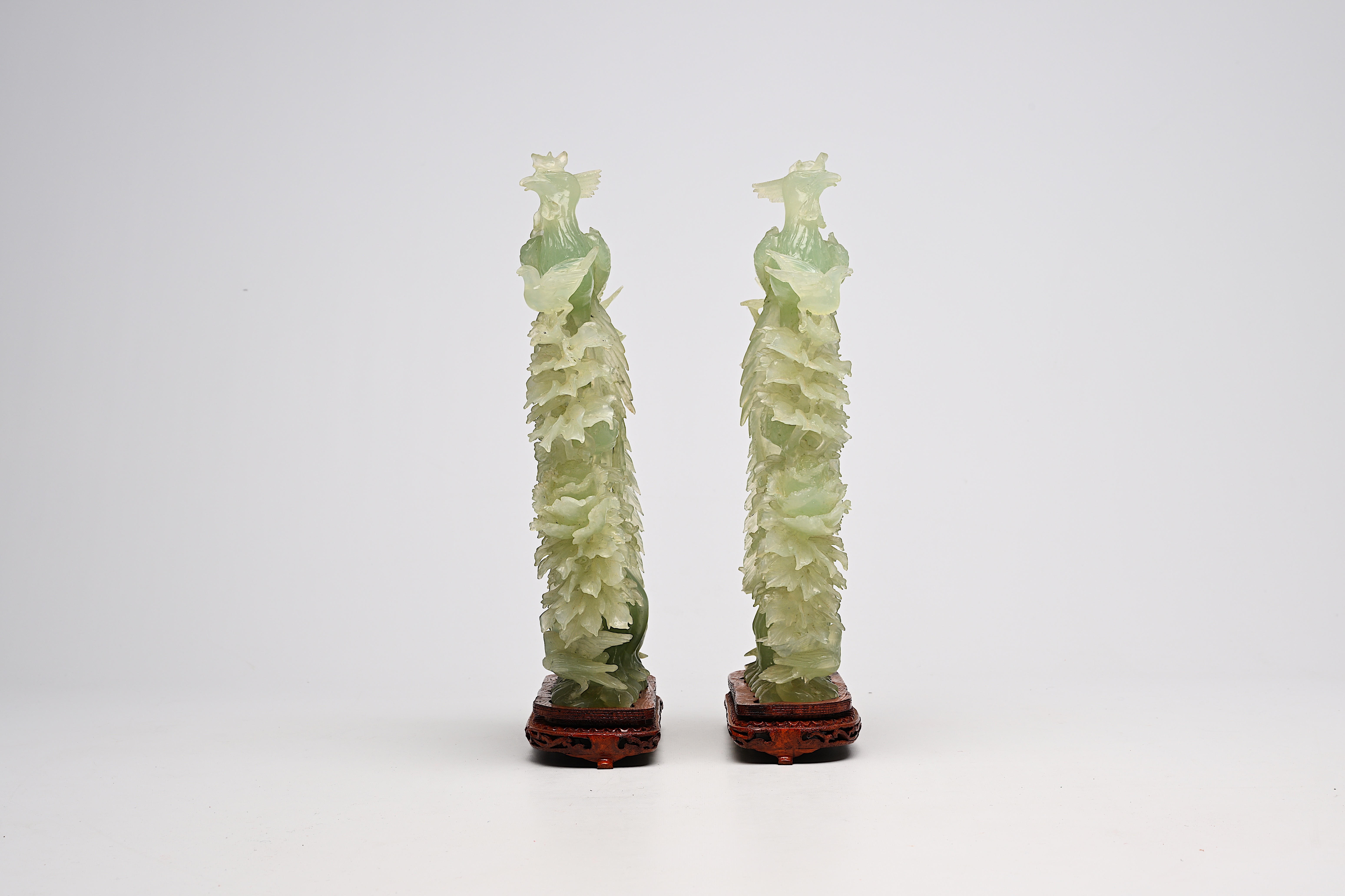 A pair of large Chinese carved jadeite groups with a phoenix among blossoming branches, 20th C. - Image 5 of 6