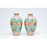 A pair of Japanese wucai style 'peony and Buddhist lions' vases, Meiji, ca. 1900