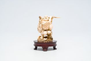 A Japanese ivory 'Happy Bouddha' okimono, signed, Meiji, late 19th C.
