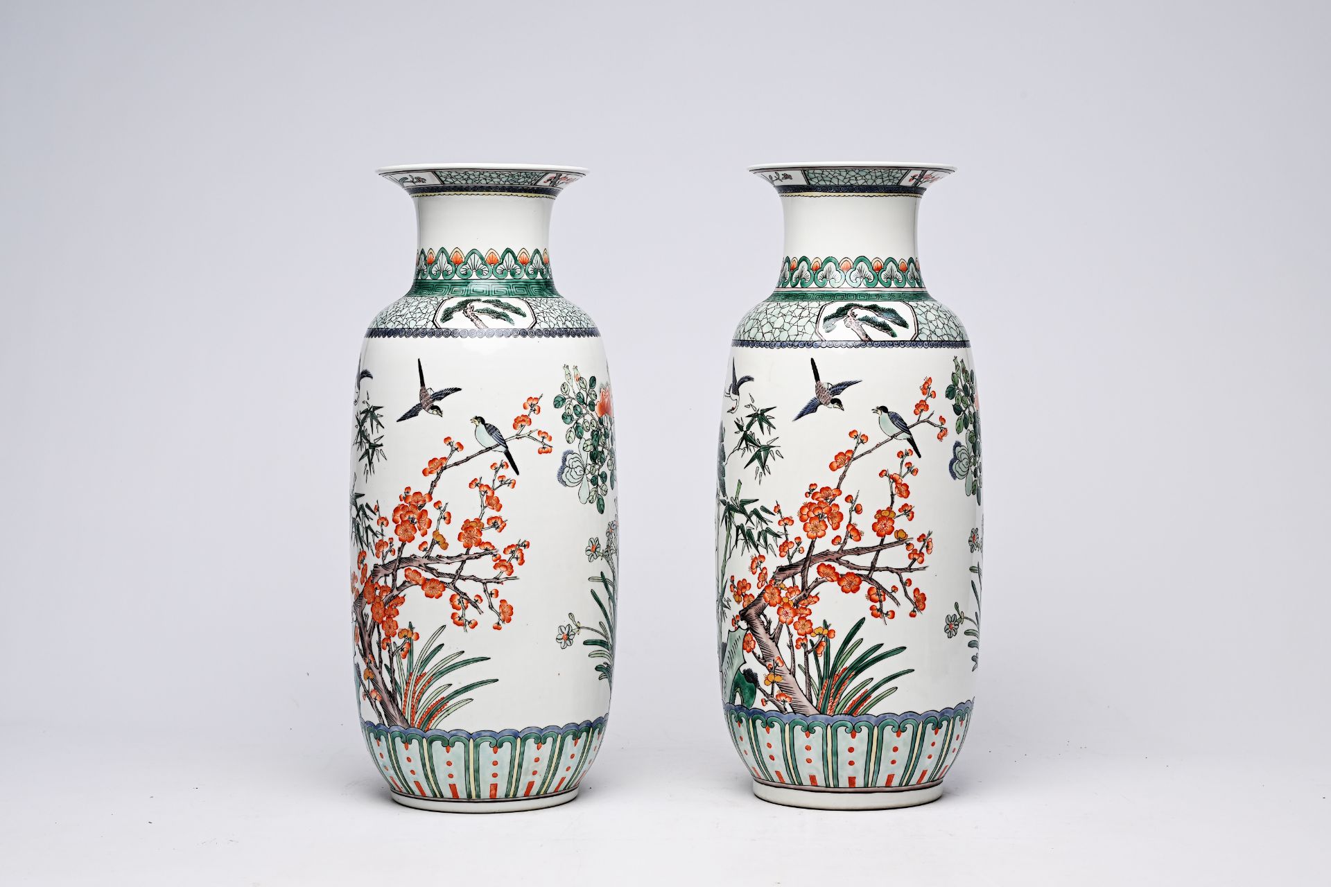 A pair of Chinese famille verte vases with birds among blossoming branches, 20th C.