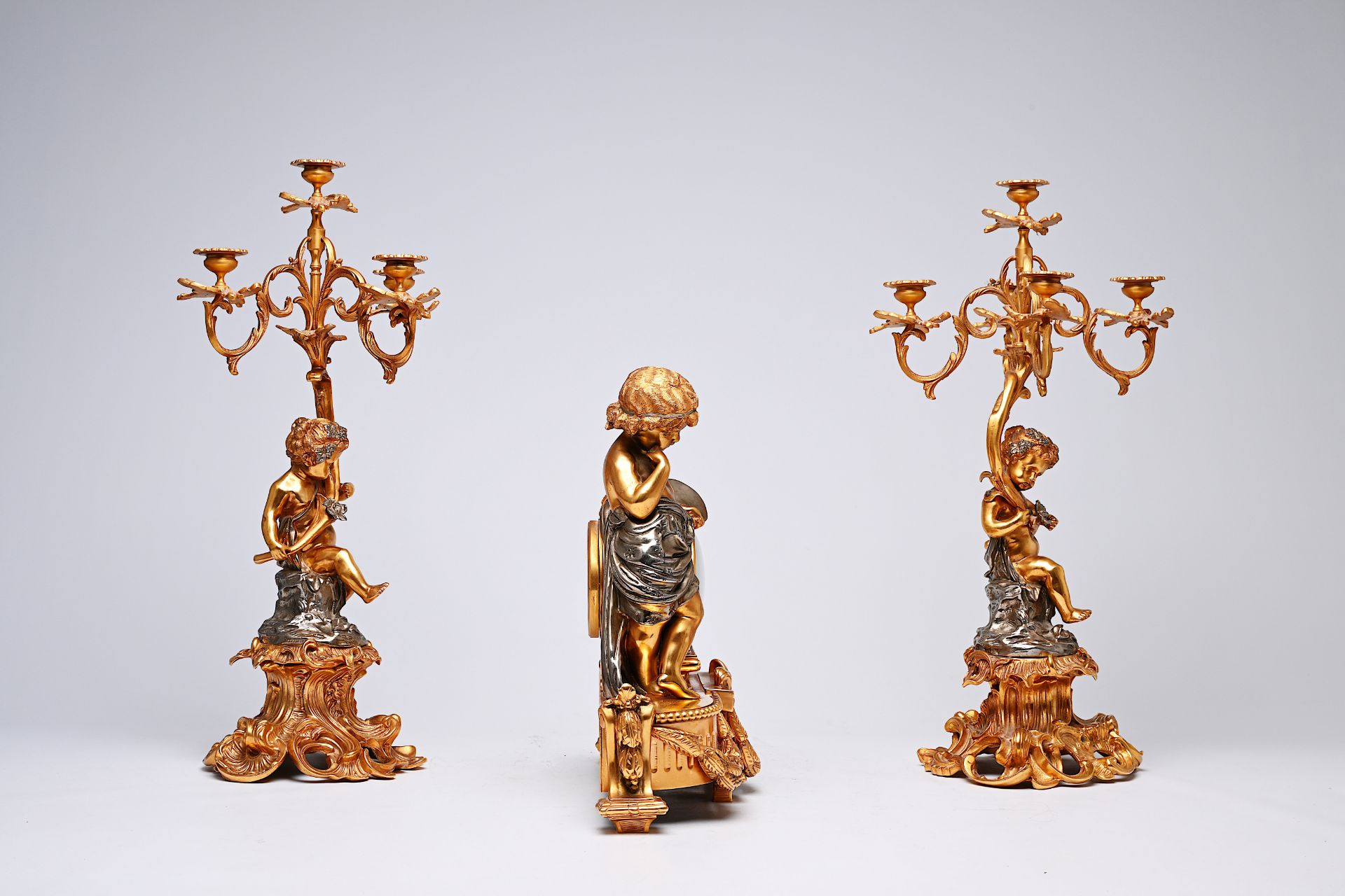 A French three-piece partly gilt metal clock garniture with putti, 20th C. - Image 3 of 11