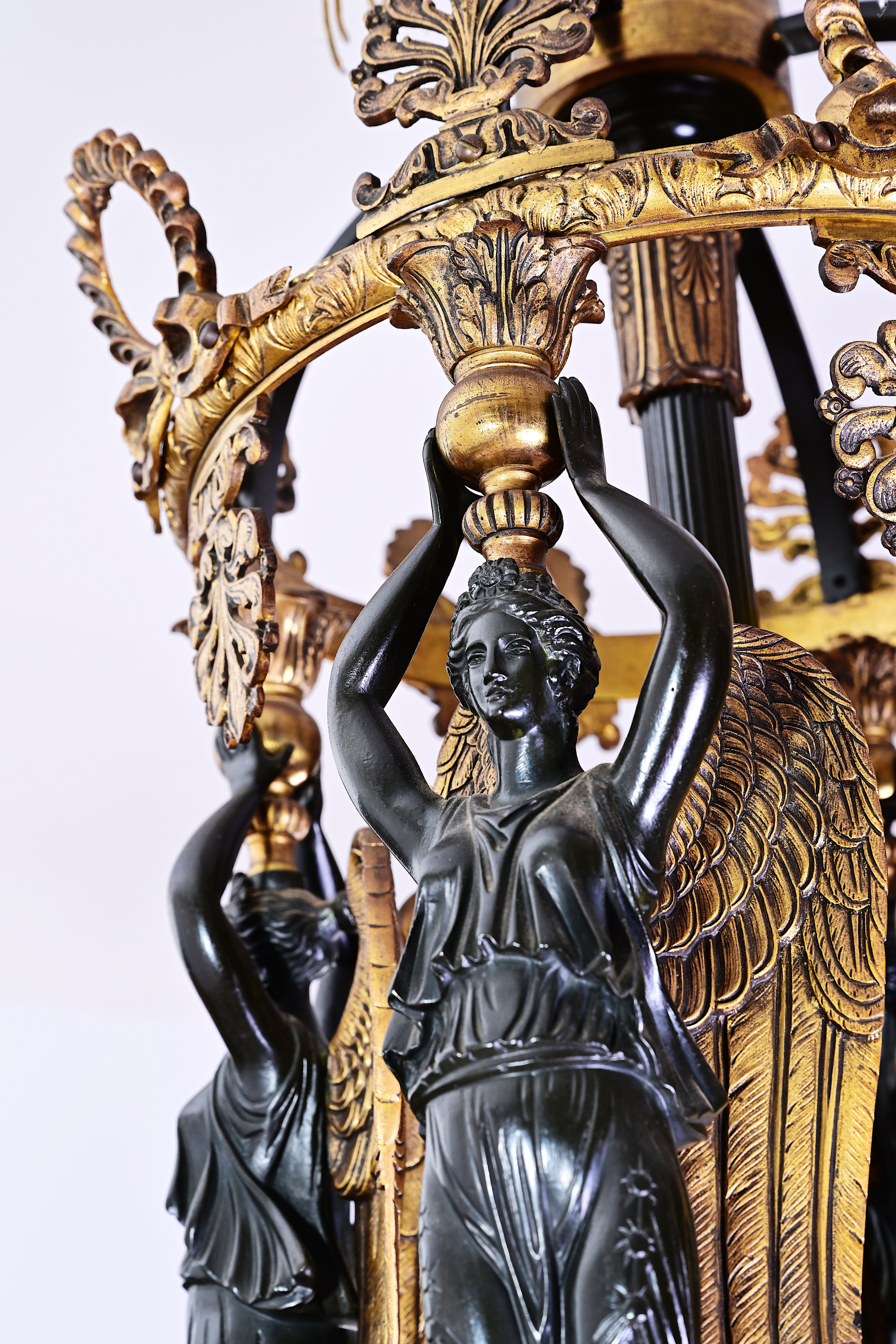 A French patinated and gilt bronze Empire style twelve-light 'caryatids' chandelier, 19th C. - Image 7 of 7