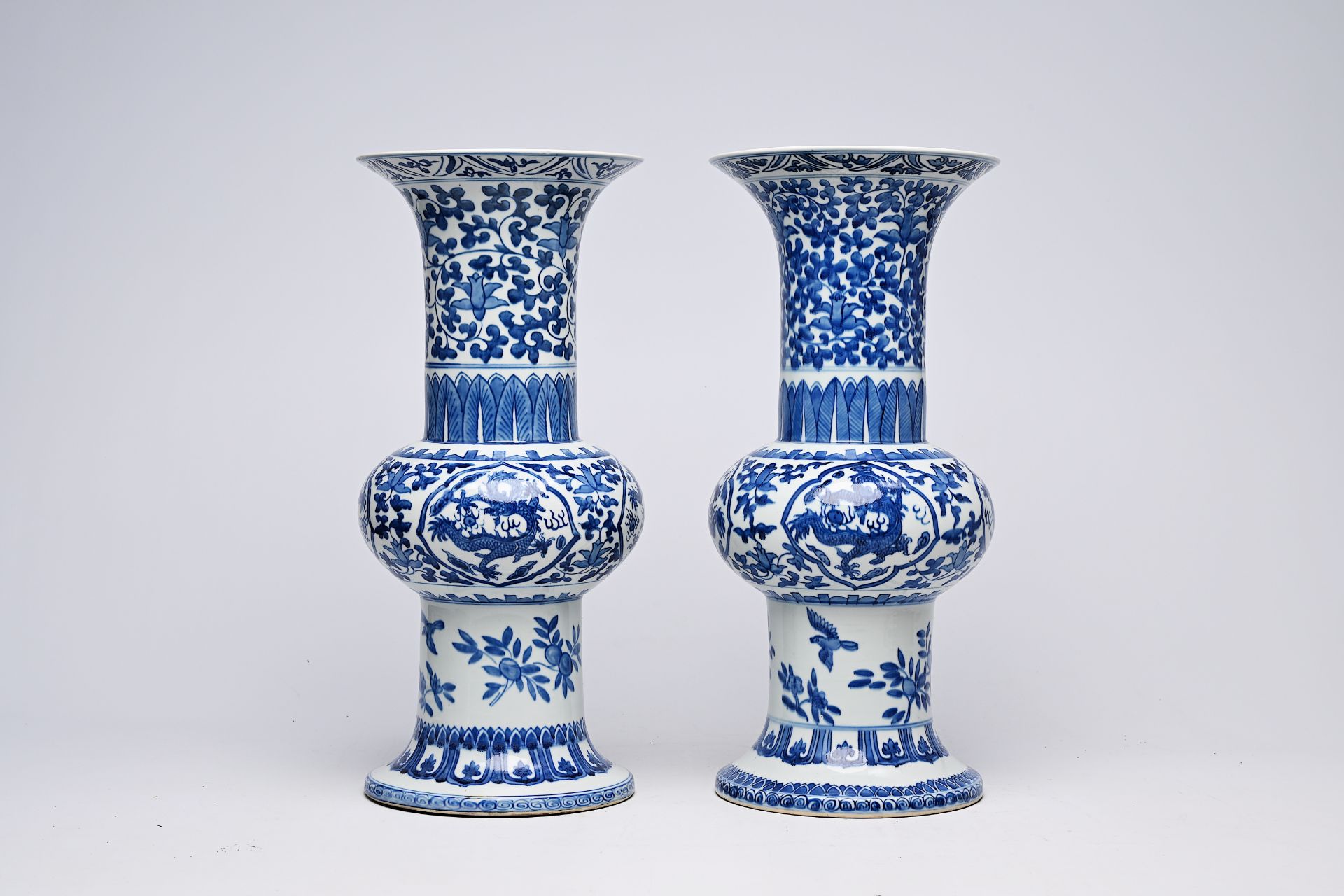 A pair of Chinese blue and white 'gu' vases with dragons and floral design, Qianlong mark, Republic, - Image 6 of 22