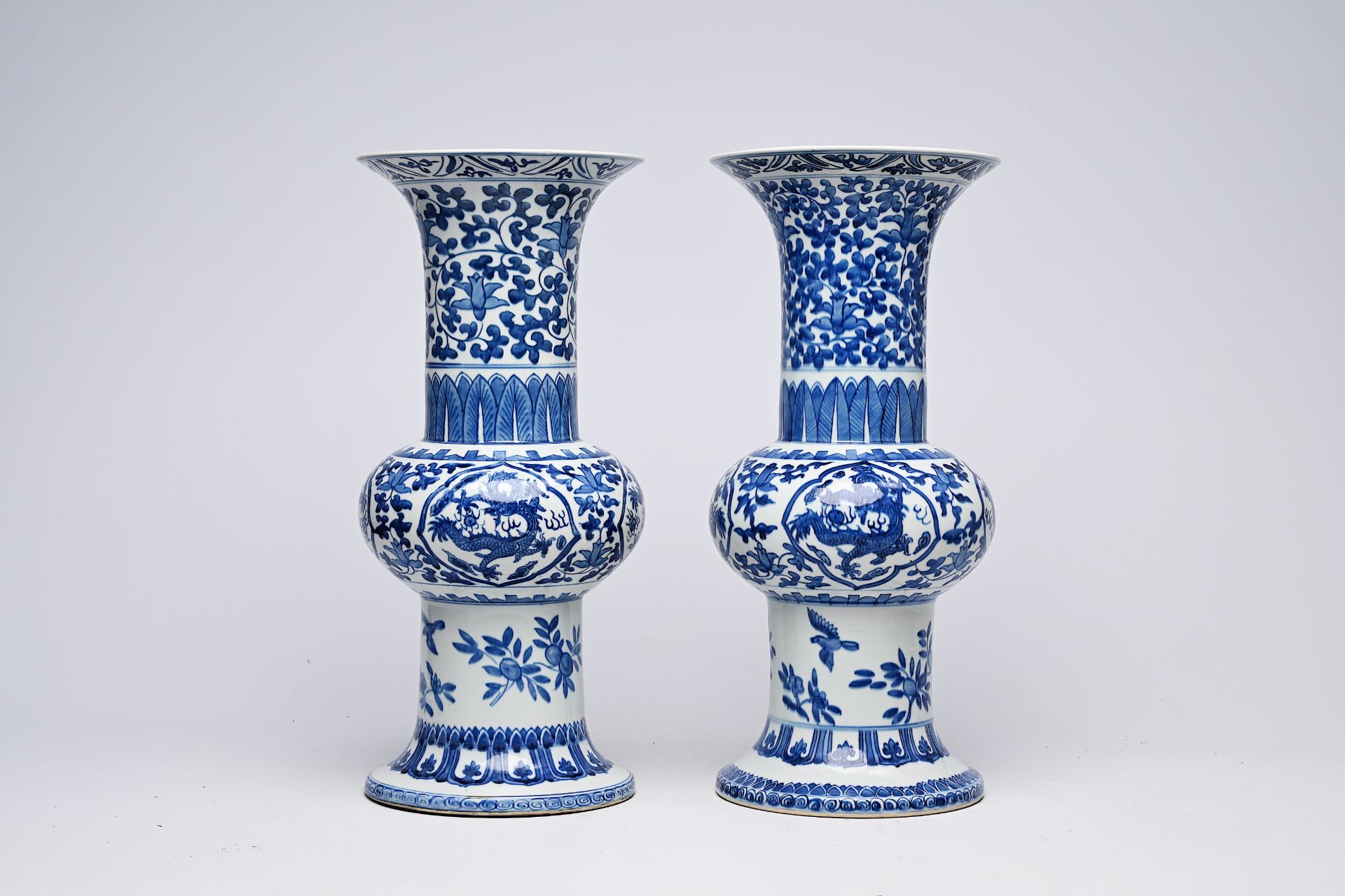 A pair of Chinese blue and white 'gu' vases with dragons and floral design, Qianlong mark, Republic, - Image 5 of 22