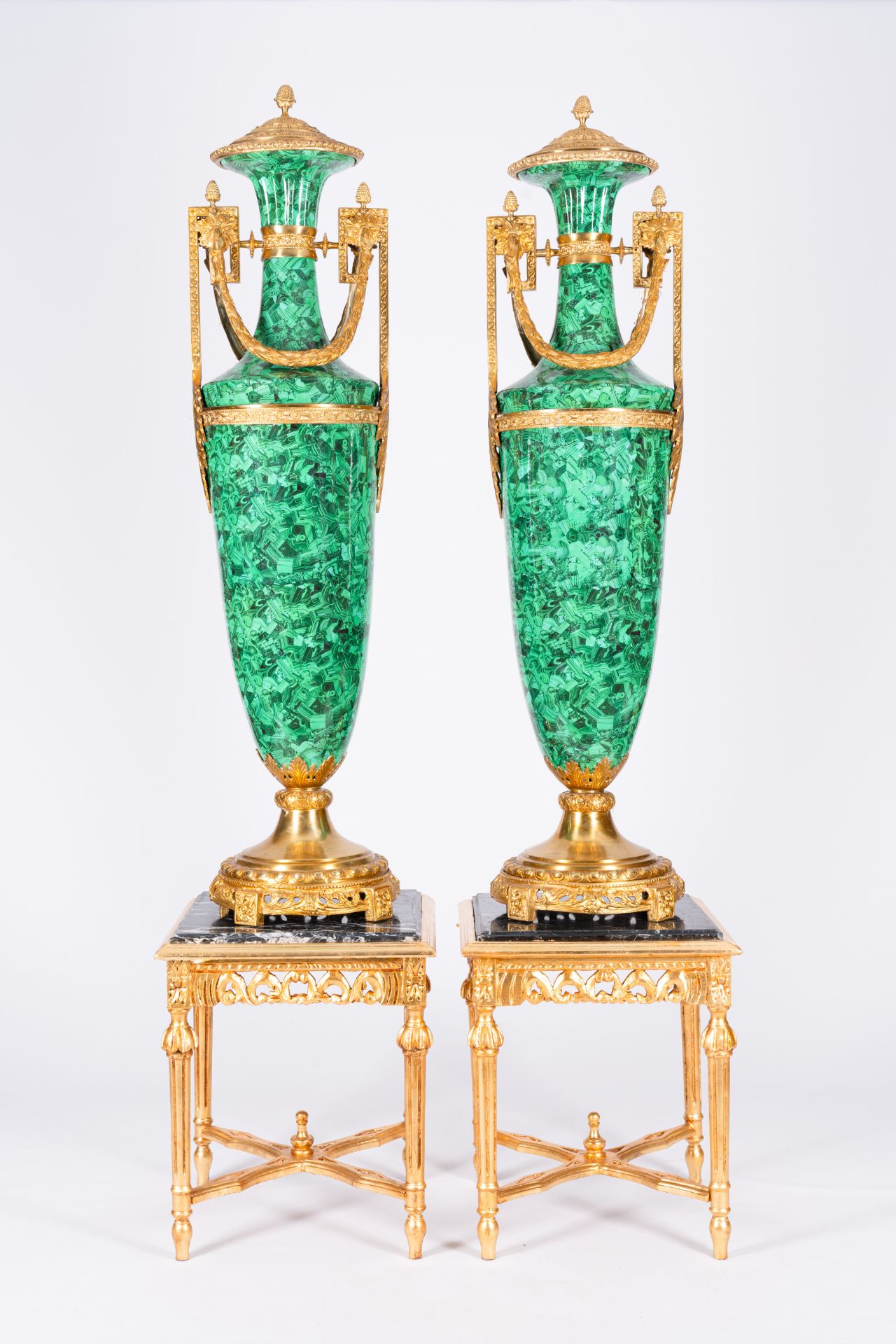 A pair of large gilt bronze mounted faux-malachite vases on matching gilt wood bases with marble top