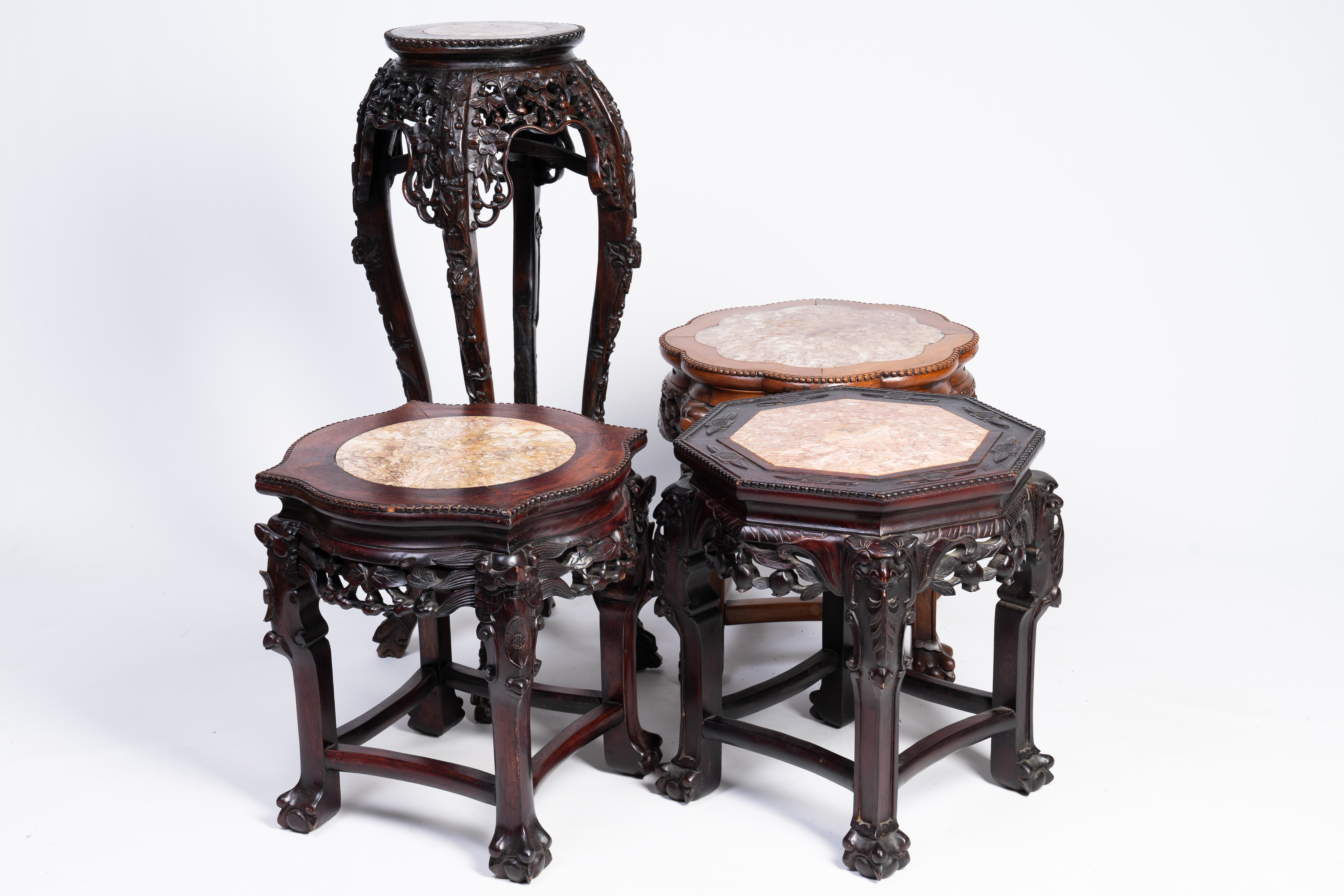Four Chinese reticulated hardwood stands with marble tops, 20th C.