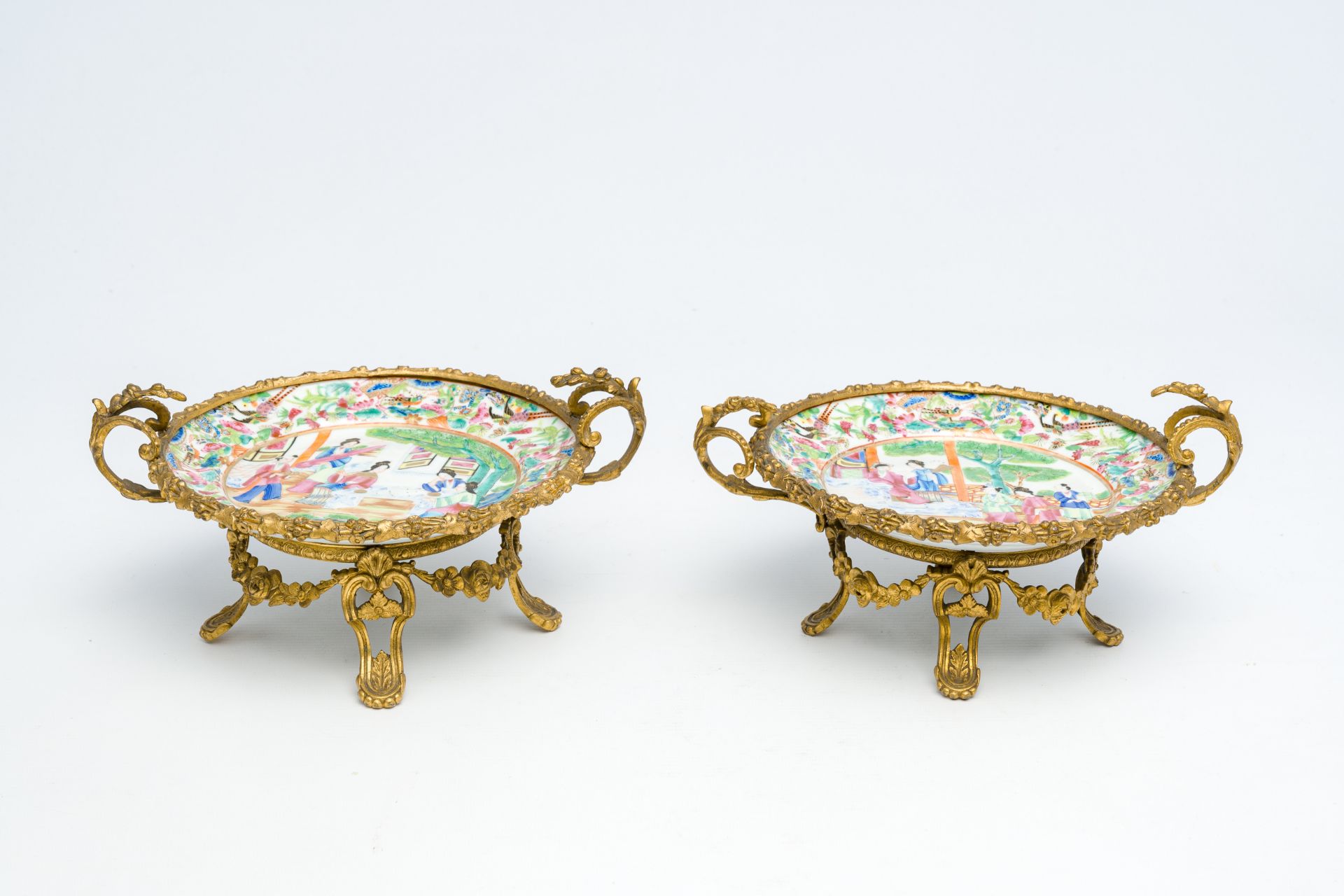 Two Chinese Canton famille rose gilt bronze mounted plates with figures on a terrace, 19th C. - Image 2 of 7