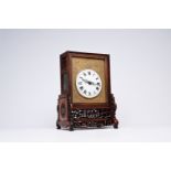 A Chinese reticulated wood fusee clock with brass plaque, 19th C.