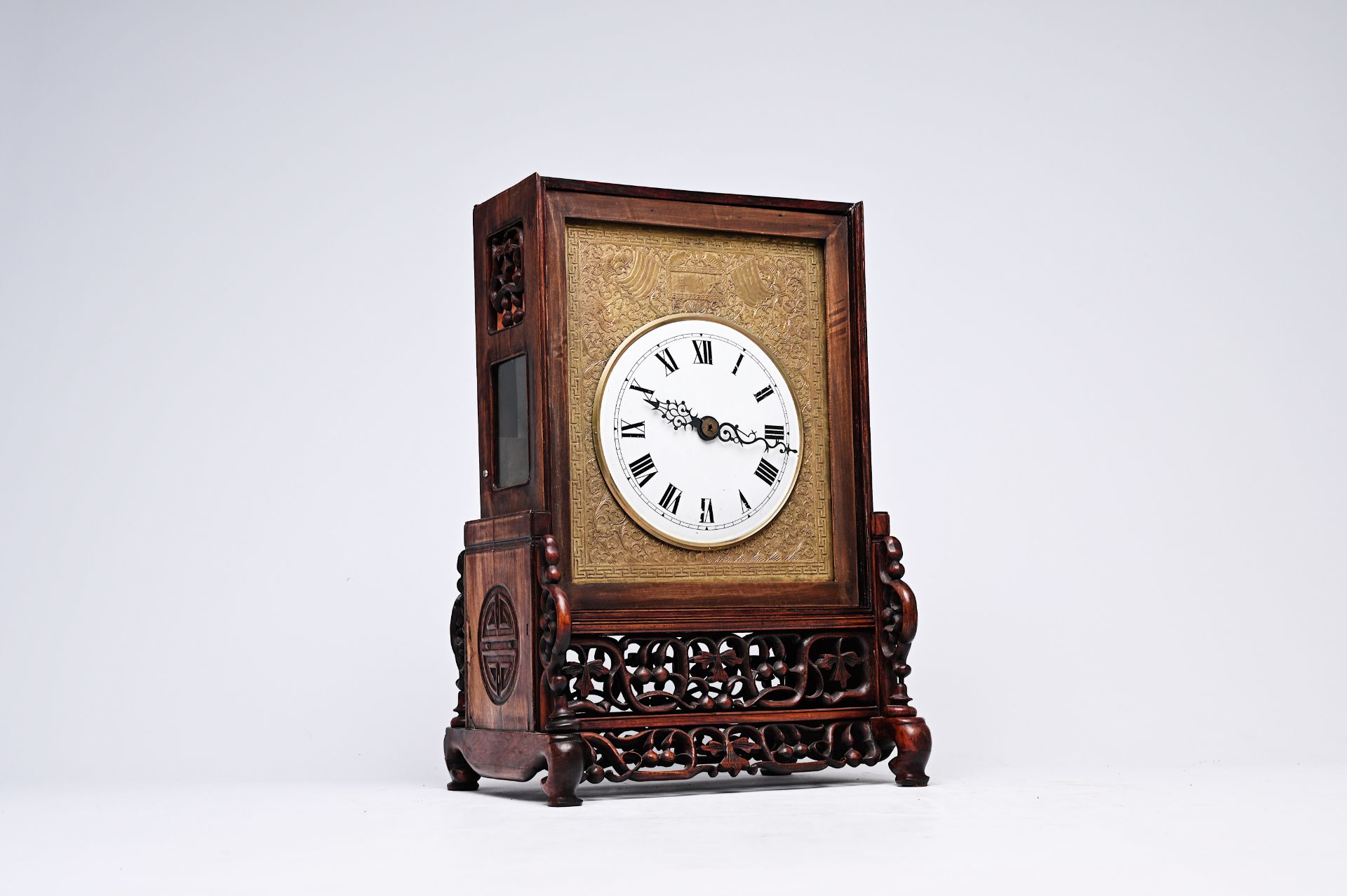 A Chinese reticulated wood fusee clock with brass plaque, 19th C.