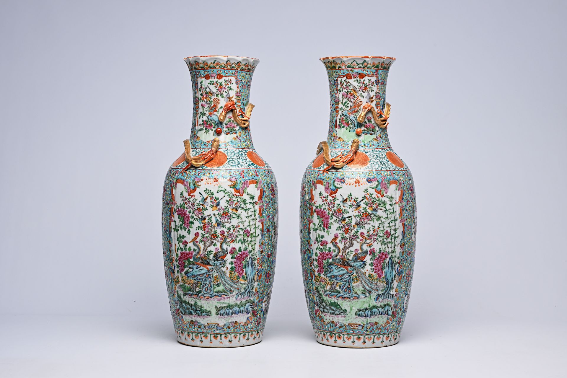 A pair of Chinese Canton famille rose turquoise ground vases with birds among blossoming branches, 1
