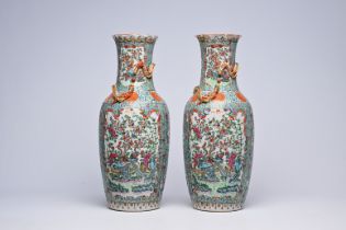 A pair of Chinese Canton famille rose turquoise ground vases with birds among blossoming branches, 1