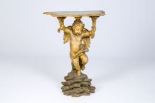 A gilt and polychrome decorated wood wall console in the shape of an angel standing on a rock, 18th