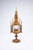 A French Gothic revival brass cathedral-shaped monstrance with enamel plaques, 19th C.