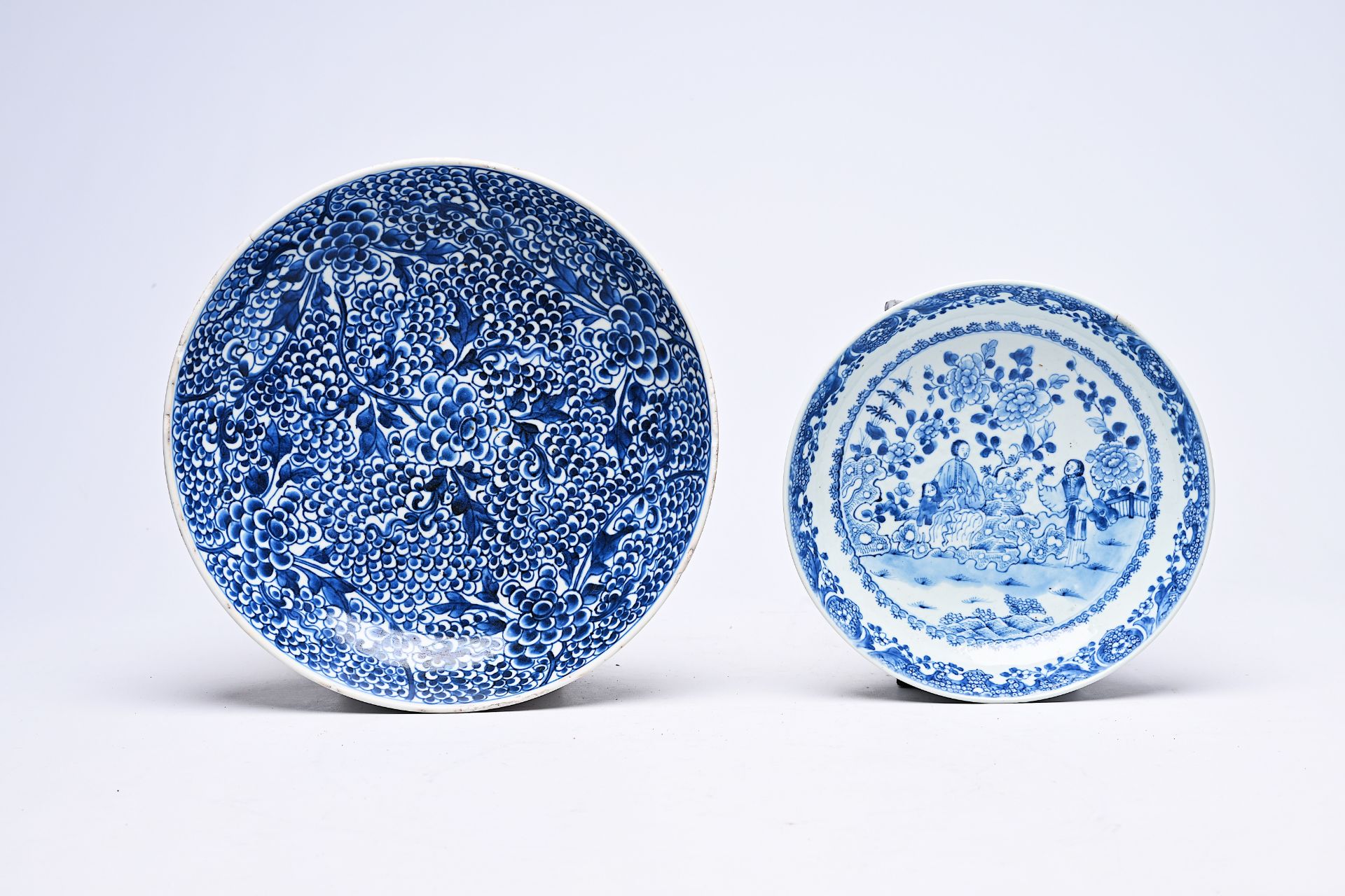 Two Chinese blue and white plates with floral design and figures in a landscape, Kangxi/Qianlong - Image 2 of 3