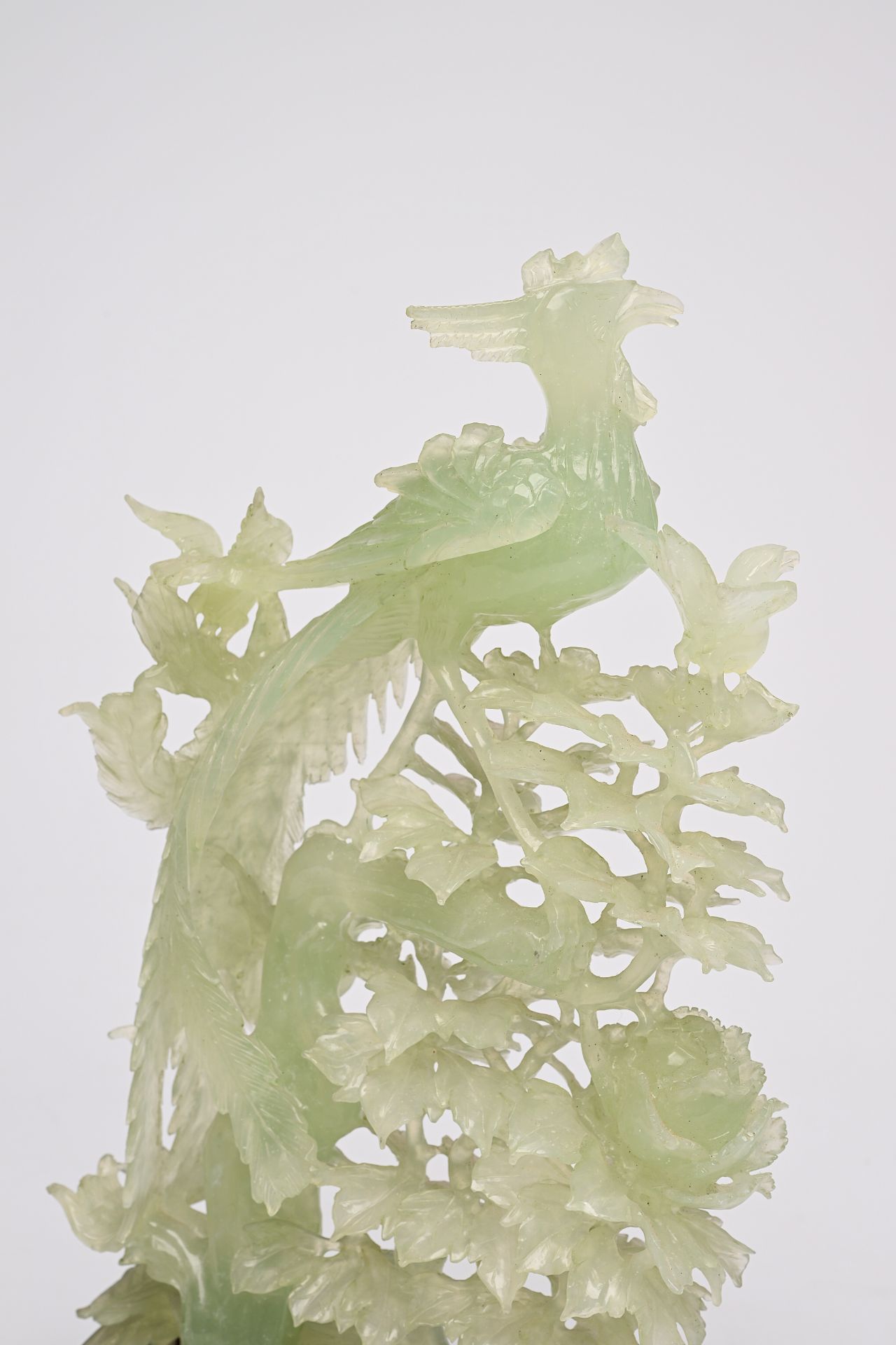 A pair of large Chinese carved jadeite groups with a phoenix among blossoming branches, 20th C. - Image 6 of 6