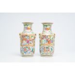 A pair of Chinese Canton famille rose vases with palace scenes and floral design, 19th C.