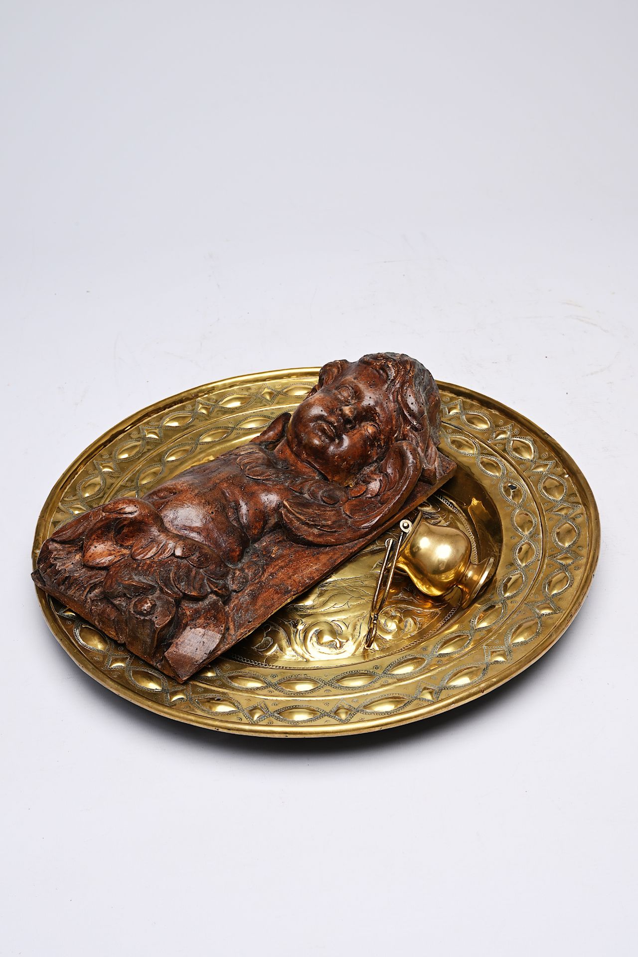 A German brass 'Adam and Eve' alms dish, a holy water font and a carved wood putto, 17th/18th C. - Image 3 of 4