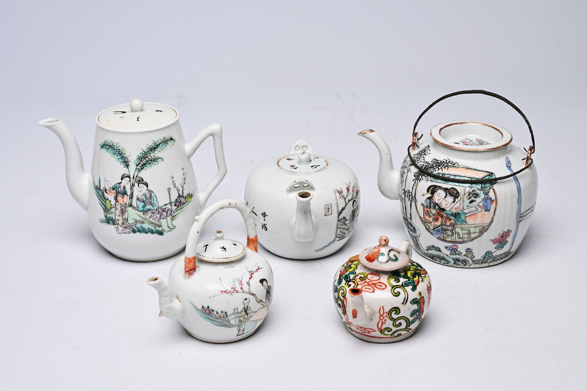 Five Chinese famille rose and qianjiang cai teapots and covers with floral and figurative design, 19