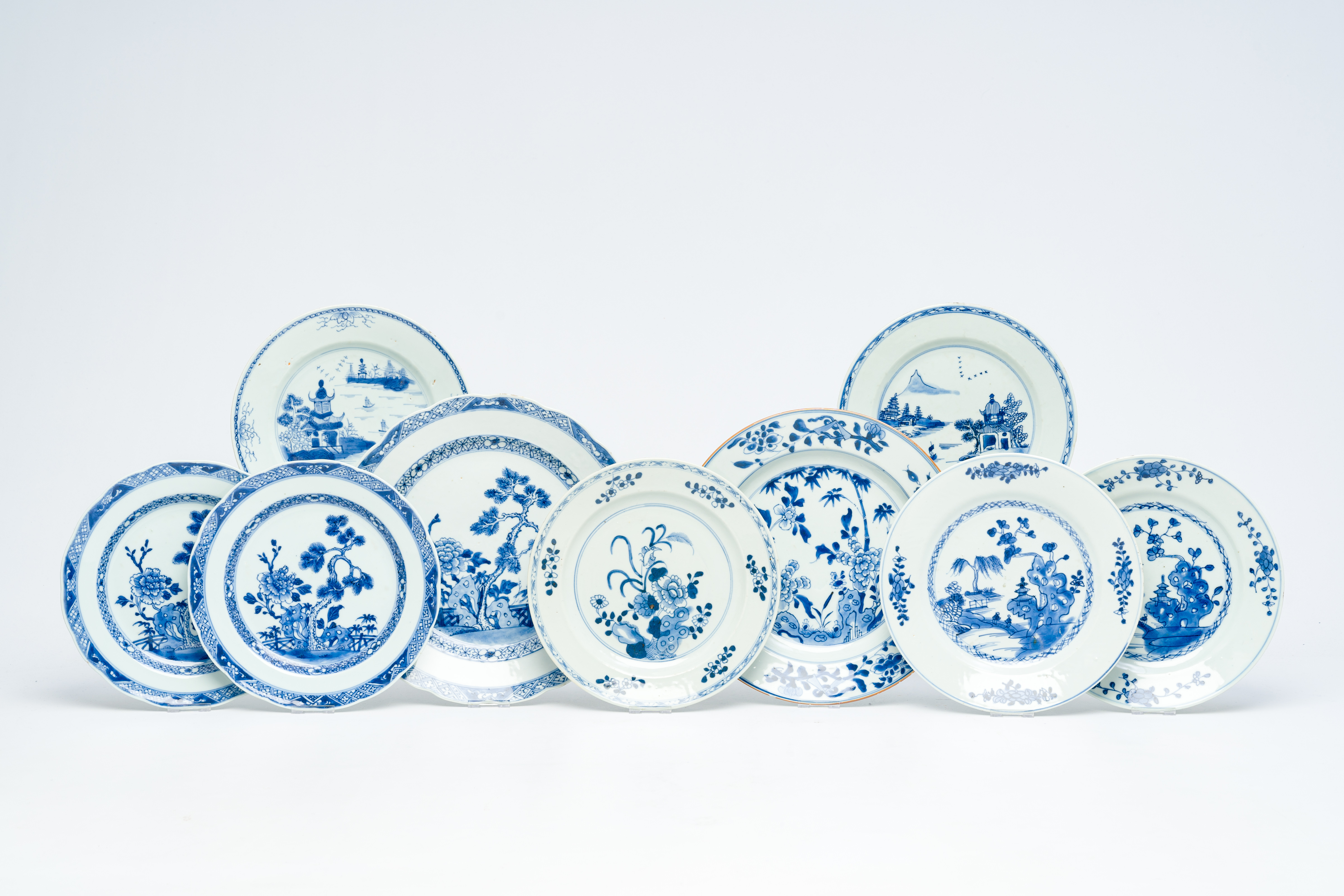 Nine Chinese blue and white plates with floral design and animated river landscapes, Yongzheng/Qianl