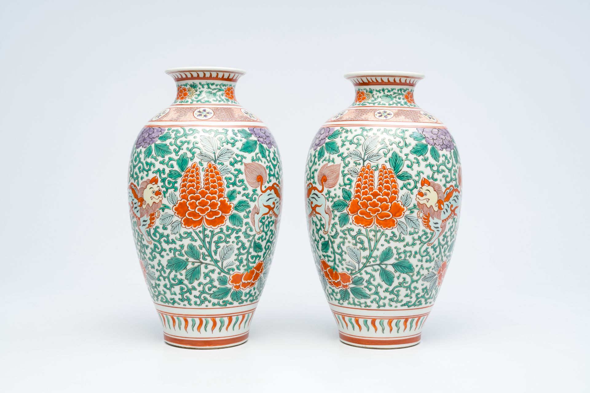 A pair of Japanese wucai style 'peony and Buddhist lions' vases, Meiji, ca. 1900 - Image 2 of 6