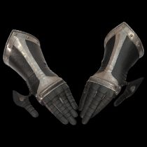 A pair of South German black and white gauntlets, last quarter of the 16th century.