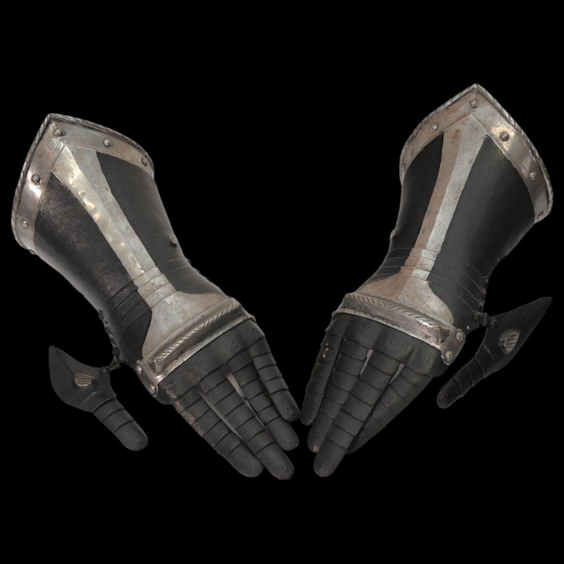 A pair of South German black and white gauntlets, last quarter of the 16th century.