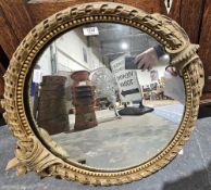 A 19th century circular mirror within a gilt painted gesso frame with scrolling and bead decoration,