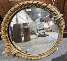 A 19th century circular mirror within a gilt painted gesso frame with scrolling and bead decoration,