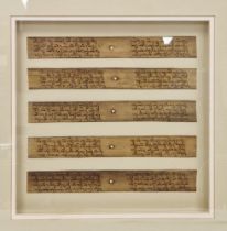 Five reproduction Asian written palm leaves, depicting religious texts, framed and glazed