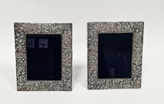 Two 20th century silver-plated photograph frames of rectangular form, embossed in repousse