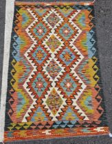 Chobi kilim, woven with geometric lozenges in blue, red, ochre on a cream ground within geometric