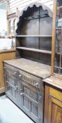 20th century oak arch-topped kitchen dresser with plate and mug rack to top, raised over two short