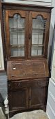 20th century oak bureau bookcase, the glazed bookcase doors opening to reveal two adjustable