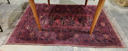 Afghan wool rug having three octagonal guls to the cherry red field, multiple geometric borders, all