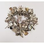 20th century silver and white metal charm bracelet, with an assortment of attached charms
