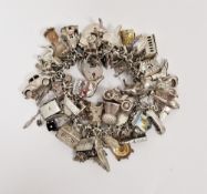 20th century silver and white metal charm bracelet, with an assortment of attached charms