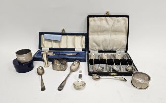 Set of six silver teaspoons in fitted case, three silver napkin rings, a continental white metal