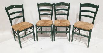 Set of four green painted wicker-seated dining chairs, each with turned legs, 89cm high