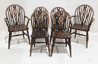 Set of six oak Windsor wheelback dining chairs including two carvers, one with label to underside
