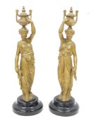 Pair of late 19th century French gilt metal-mounted figures of water carriers, each cast holding a