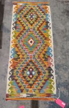 Chobi kilim runner having three chevron bordered lozenge medallions and hooked borders, 150cm x 63cm