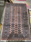 Eastern wool rug with two rows of multiple quartered guls on a madder field, flowerhead and formal