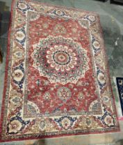 Persian-style Eastern wool rug, the red field with single large flowerhead arabesque, allover